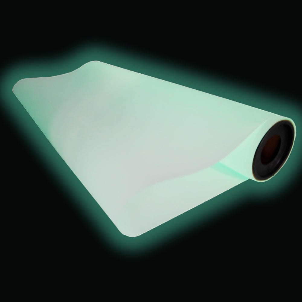Partially unrolled glow-in-the-dark DTF film showing luminous green glow