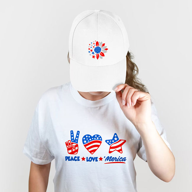 Finished DTF transfers on a white t-shirt and baseball cap with patriotic graphics