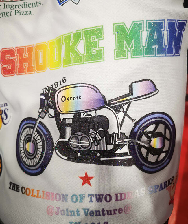 Glitter DTF transfer on white mesh fabric showing a rainbow motorcycle graphic with sparkle texture