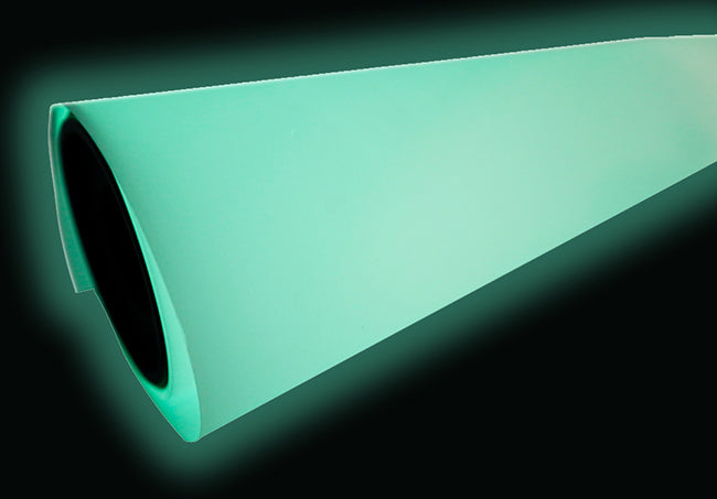 Glow-in-the-dark DTF film roll emitting a mint-green glow against a black background